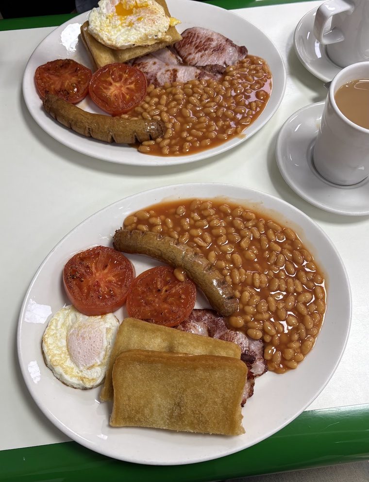 A full English breakfast with sausage, bacon, egg, beans, tomato and fried bread
